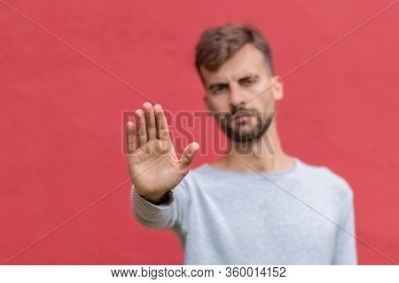 Man Showing Interlocutor Hand Gesture To Keep Distance. Guy Keeping Distance With Hand. Male Showing