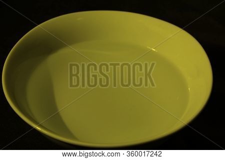 White Bowl Filled With Water On Black Background