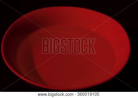 White Bowl Filled With Water On Black Background