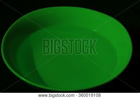 White Bowl Filled With Water On Black Background