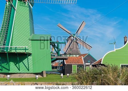 Traditional Windmill In The Zaanse Schans, A Neighborhood With Historic Wooden Buildings In The Muni