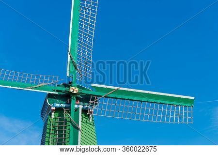 Traditional Windmill In The Zaanse Schans, A Neighborhood With Historic Wooden Buildings In The Muni