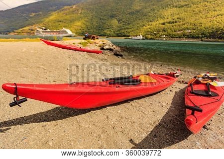Kayaks On Shore And Cruise Ship On Fjord In Norwegian Tourist Destination Flam Village.