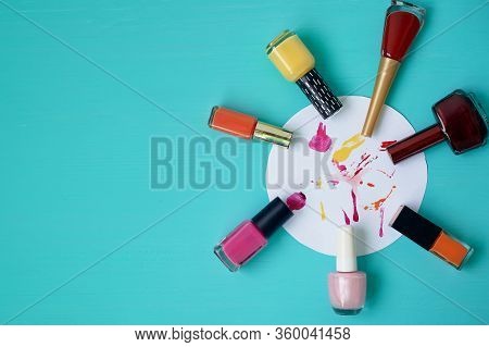 Colorful Varnishes On A Turquoise Background. On A Piece Of Paper Chaotic Drawing Of Varnishes. A Pa