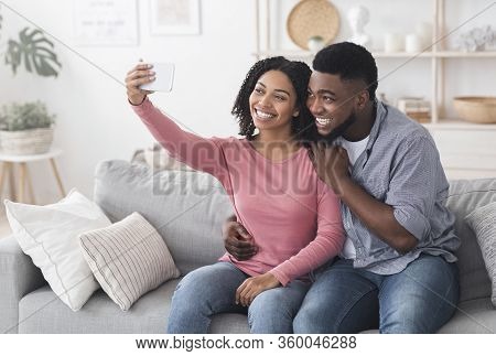 Quarantine Selfie. Smiling Black Couple Taking Photo On Smartphone At Home, Capturing Happy Moments,