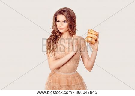 Diet Concept. No For Fast Fat Food. Woman Refuses To Eat Tasty Cheese Burgers In Her Hand, She Is Ab