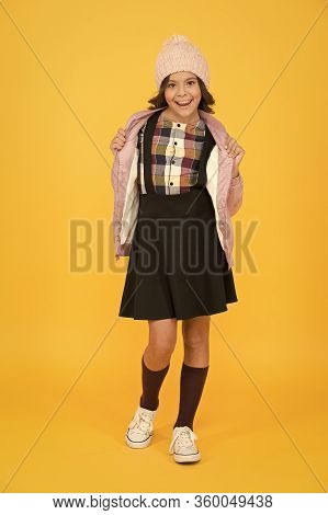 Welcome To School. Small Girl In Uniform. Cheerful Child Yellow Background. Beauty And Fashion For K