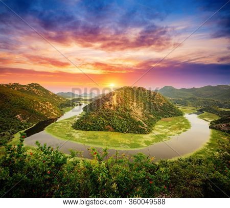 Splendid scene of winding river Rijeka Crnojevica flowing through mountains. Location National park Skadar Lake, Montenegro, Balkans, Europe. Exotic summer scene. Explore the beauty of earth.