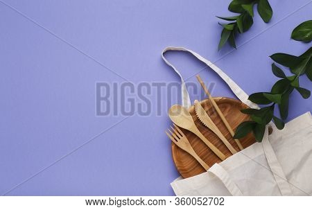 Eco-friendly Plate, Cutlery And Cotton Eco Bag On Violet Background