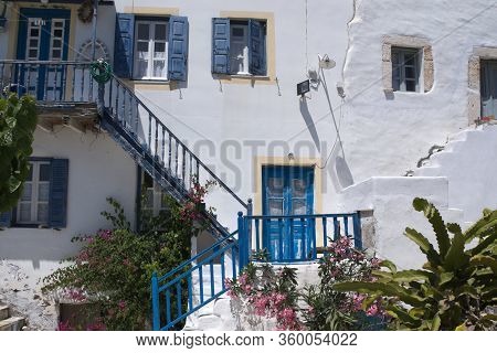 A View Of The Historic Kastro On The Greek Island Of Antiparos. A Rickety Staircase Leads Up To A Ho