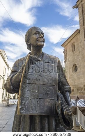 Caceres, Spain - Nov 7th, 2019: Newspapers Saleswoman Bronze Sculpture. Memorial Statue To Leoncia G