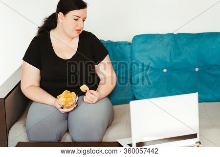 Mindless Snacking, Home Sedentary Lifestyle, Compulsive Overeating. Obese Lazy Woman Sitting On Sofa