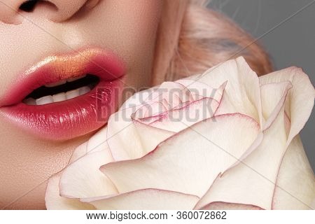 Close-up Of Beautiful Lips With Bright Kissed Makeup And Gold Glitter. Fashion Red Tint Visage With