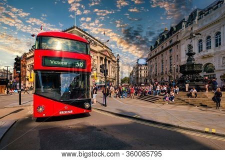 LONDON,UK - AUGUST 19,2019 : A traditional red double decker bus at the worldwide famous Piccadilly Circus