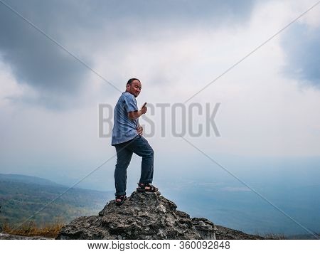 Asian Fat Trekker On Yeabmek Cliff Phu Kradueng Mountain National Park In Loei City Thailand.phu Kra