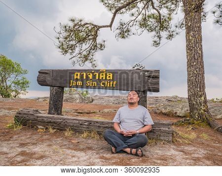 Asian Fat Trekker On Jamsin Cliff On Phu Kradueng Mountain National Park In Loei City Thailand.phu K