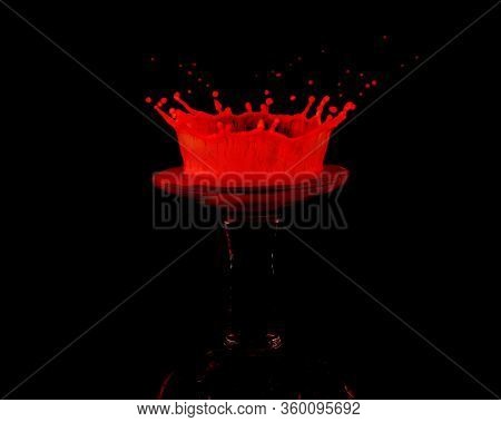 A Red Drop Of Milk Splashed Onto An Upturned Miniature Wine Glass Creates A Crown Shaped Splat Again