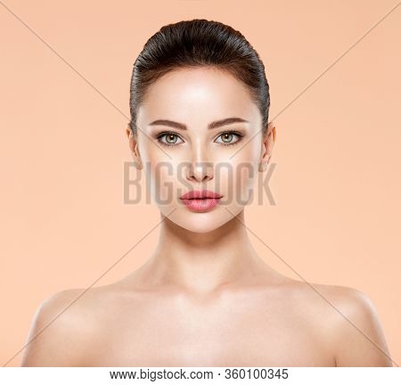 Portrait of beautiful young brunette woman with clean face. Closeup face of young adult woman with clean fresh skin. Front portrait of woman with beauty face. Beauty concept 