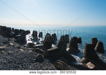 Tetrapod Breakwaters On The Coast. Concrete Breakwaters Of Tetrapods Lie All Along The Coast.