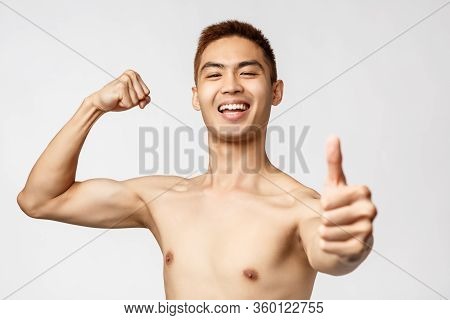 Workout, Lifestyle And Health Concept. Portrait Of Proud, Boastful Handsome Asian Man Flex Biceps, B