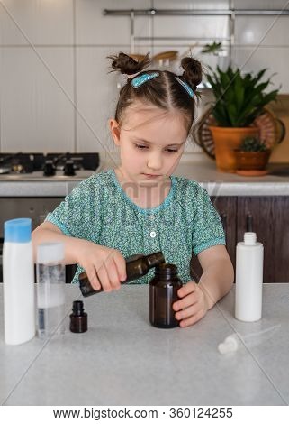 Kid Girl Makes Sanitaizer Or Antiseptic Gel At Home. Hygiene During Coronavirus Epidemic. Concept Of