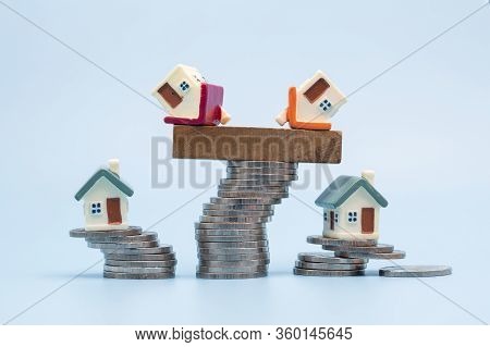 Mini House On Stack Of Coins,money And House,  Mortgage, Savings Money For Buy House And Loan To Bus