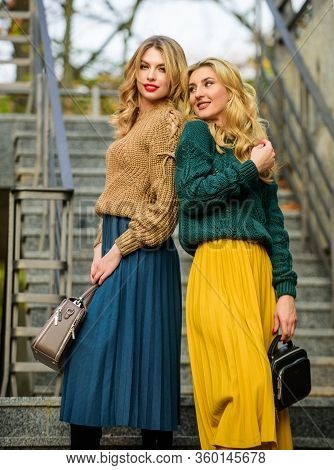 Completing Each Other. Matching Outfits. Women Sisters Outdoors Stairs Background. Vogue Concept. Gi