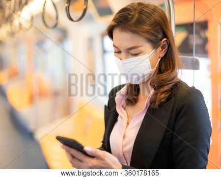 Bueatiful Adult Asian Businesswoman Passenger Wearing Medical Hygiene Protect Mask. Standing And Usi