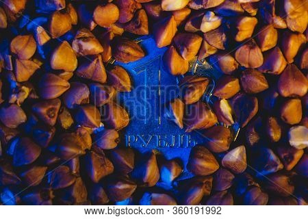 One Ruble Coin In Buckwheat Under Blue Light