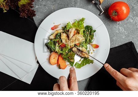 Caesar Salad With Chicken Eats Man. Photo From Above.