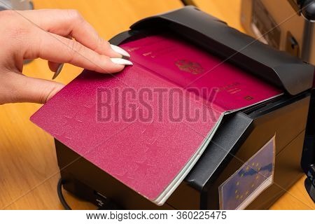 The Process Of Scanning A German Biometric Passport To Register The Fact Of Crossing The State Borde