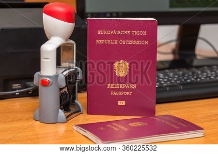 Close-up Of Austrian Biometric Passport With A Date Stamper, Interstate Border In Europe. Inscriptio