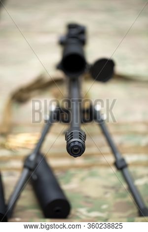 Rifle With A Silencer On The Range.