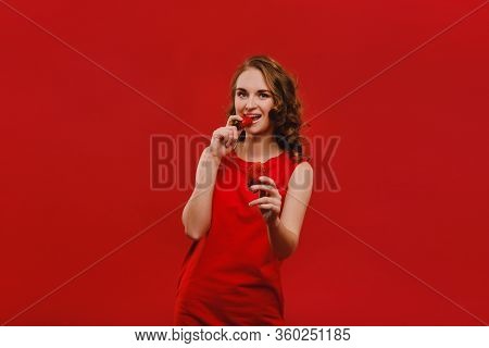 Sweet Strawberries. Beautiful Bright Girl In Retro Style Eating A Strawberry. Happy Pin Up Woman Iso
