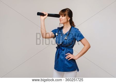 Female Brunette Doctor Looking At Tomography X-ray Film