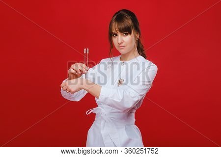 Beautiful Girl Doctor With A Tuning Fork Stands