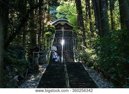 Tosa, Kochi Prefecture, Japan - April 7, 2018: O-henro Pilgrims Climbing The Steep Stairs Leading To
