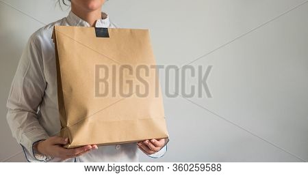 Chef Making A Delivery Of Food Takeaway In A Paper Carton Bag With Copy Space.