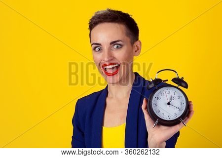 Anticipation. Headshot Young Funny Looking Excited Business Woman Holding Alarm Clock Waiting Isolat