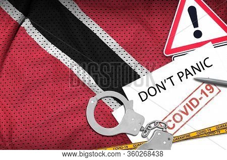 Trinidad And Tobago Flag And Police Handcuffs With Inscription Dont Panic On White Paper. Coronaviru