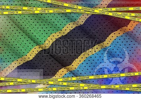 Tanzania Flag And Covid-19 Quarantine Yellow Tape. Coronavirus Or 2019-ncov Virus Concept