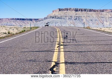 Car Driving On Scenic State Route 24 Running Through Desert Near Caineville - Utah, Usa