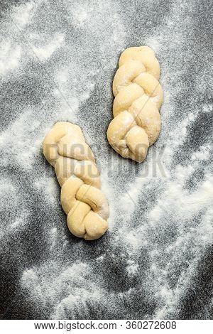 Unbaked braided bun dough. Raw dough. Unbaked buns. Top view.