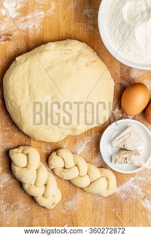 Unbaked braided bun dough. Raw dough. Unbaked buns. Top view.