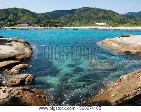 Sandstone Rock Formations And Clear Blue Waters At Tatsukushi Coast - A Natural Scenic Landmark Near