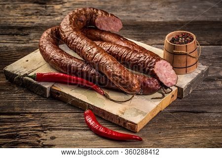 Assortment Of Cold Meats, Variety Of Processed Cold Meat Products. On A Wooden Background.