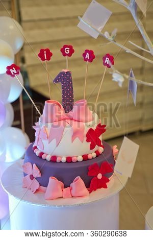 Nigar Inscription With Candles . A Purple Inscription. A Wet Birthday Cake.