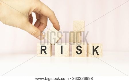 Risk Word On Blocks Arranged Behind The Ruler On A Light Background.
