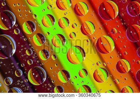 Color Pencils Under Glass With Drops Of Water.  Office Concept.