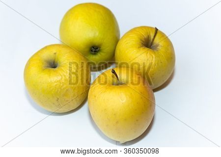 Several Old Dried Yellow Apples On A White Background